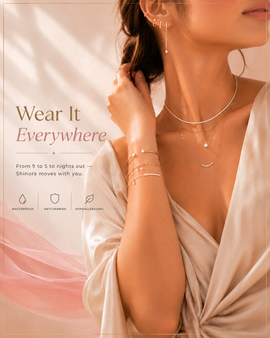 A close-up lifestyle shot of a woman wearing delicate layered silver jewelry, including a necklace, bracelets, and earrings, paired with a cream satin robe. Text on the left reads 'Wear It Everywhere' with feature icons for waterproof, anti tarnish, and hygroscopic properties.
